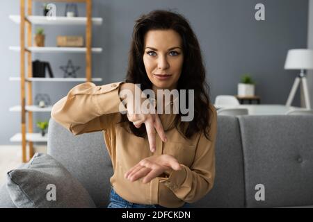 Adult Learning Sign Language For Deaf Disabled Stock Photo