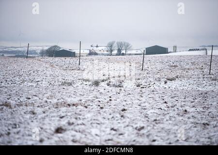 Glasgow, Scotland, UK. 4th Dec, 2020. Pictured: Snow covered moorland. Whitelee wind farm and Eaglesham Moor has the snow still lying on the ground with brown slush on the road. Credit: Colin Fisher/Alamy Live News Stock Photo