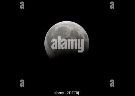 Large moon close-up at night on a black background, isolated Stock Photo