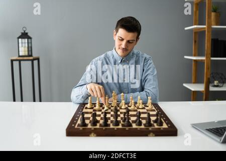 Man Playing Chess Online Using Video Conference Call Stock Photo