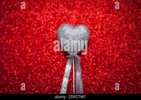 red shiny background with silver hearts, love, Valentine's Day, texture abstract background, romantic picture, suitable for advertisement, insert text Stock Photo