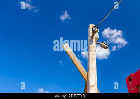 Security cameras are placed on the wooden pole for protection. Stock Photo