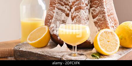 Limoncello creamy texture. Traditional Italian liqueur with pastries for Pandoro Christmas. Festive food and drinks from antique italy. High quality photo. Banner. Copy space.  Stock Photo