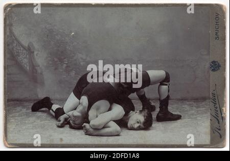 Two fighting wrestlers depicted in the black and white vintage photograph pictured by Czech photographer Karel Smolka probably in the beginning of the 20th century in his atelier in Smíchov district in Prague, Austro-Hungarian Empire. Courtesy of the Azoor Photo Collection. Stock Photo