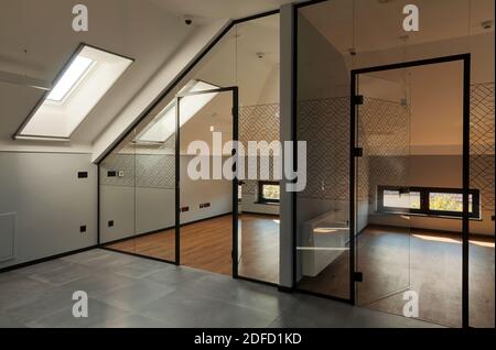 Interior of modern offices, entry walls and doors made of glass, loft part of a building. Stock Photo