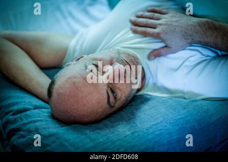 Man lying in bed. Stock Photo