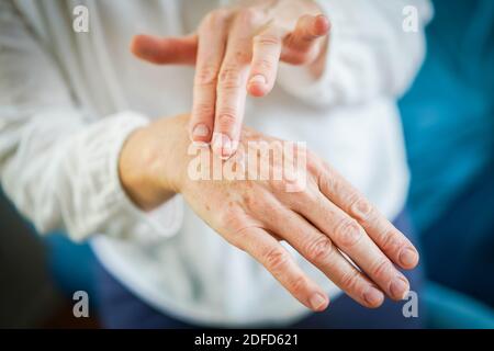Woman applying cream on her hands. Stock Photo