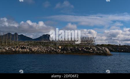 Wooden drying flakes for preservation of traditional stockfish in the harbor of Svolvær, Austvågøya island, Lofoten, Norway on coast of Norwegian Sea. Stock Photo