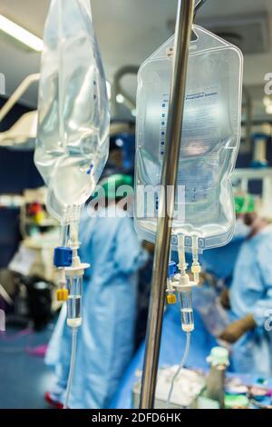 Sodium chloride bags in an operating theater, France. Stock Photo