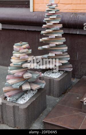 Recycled eco friendly Christmas trees of pyramid shape made from parquet distressed wood boards. Alternative Christmas tree instead of natural fir to Stock Photo