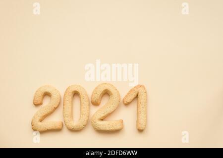 flat lay composition of gingerbread gingerbread figures 2021 home baking on the background of Set Sail Champagne-beige trend of 2021. Stock Photo