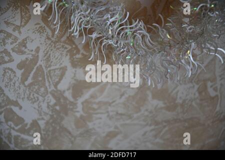 Defocus glitter silver tinsel on blurred marbled effect backdrop. Abstract Christmas background with copy space Stock Photo