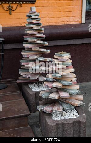 Eco friendly Christmas trees of pyramid shape made from recycled parquet wood boards. Alternative Christmas tree instead of natural fir Stock Photo