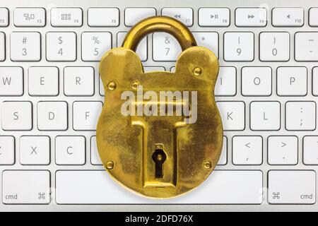 Computer keyboard with brass antique padlock Stock Photo