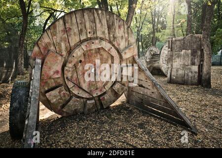 An old wooden circular building at the base for a paintball game, behind which players are hiding in search of rescue Stock Photo
