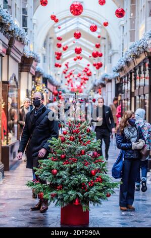 London, UK. 4th Dec, 2020. Burlington Arcade is decorated for Christmas and is now busy, as shoppers are out in force now the shops are open again. But these are still difficult times for retailers as they try to catch up after the second Coronavirus lockdown ends. Credit: Guy Bell/Alamy Live News Stock Photo