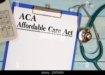 Paper with ACA Affardable Care Act on the office table, calculator and stethoscope. Medical concept. Stock Photo