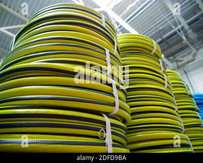 New irrigation hoses stacked in a warehouse Stock Photo