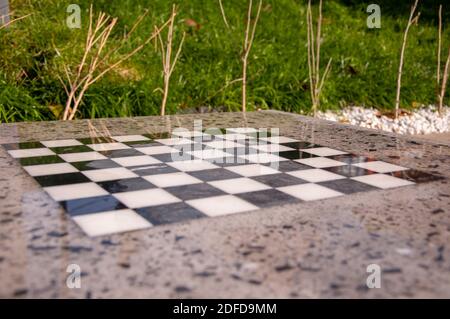 chessboard on granite table in the park Stock Photo