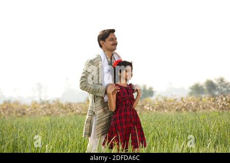 Happy Indian father and daughter in agricultural field Stock Photo