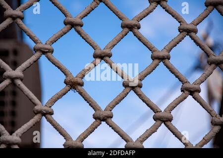 Closeup of vintage grille with shabby paint against blue sky Stock Photo
