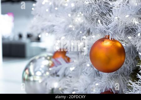 Large, beautiful Christmas balls on a white Christmas tree. Happy new year congratulation concept. High quality photo Stock Photo