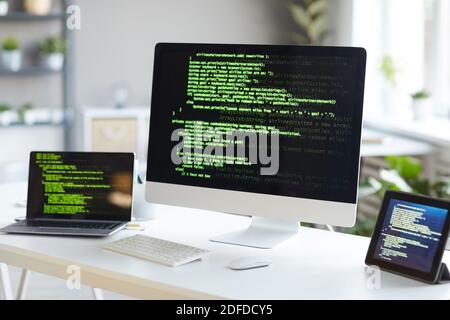 Image of computer monitor with computer programmer laptop and digital tablet on the table at office Stock Photo