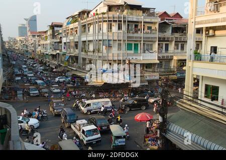 Phnom Penh, Cambodia - March, 2015: Traffic jam on a road intersection. Stuck in a traffic with crowd of motorbikes and car on the crossroad. Stock Photo