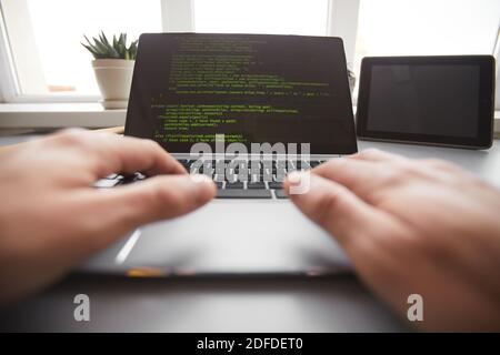 Close-up of programmer typing on laptop programming new system for online work Stock Photo