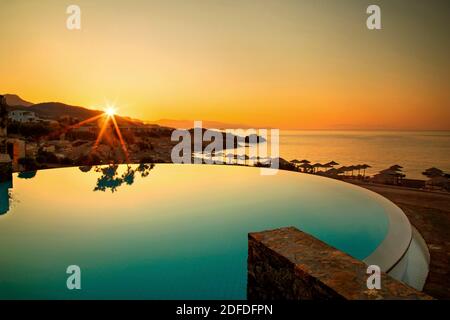 Sunrise by the pool of Kakkos beach hotel (adults only), Koutsounari, municipality of Ierapetra, Lassithi, Crete, Greece. Stock Photo