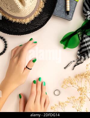 Manicured womans hands with travel assesories on beige background Stock Photo
