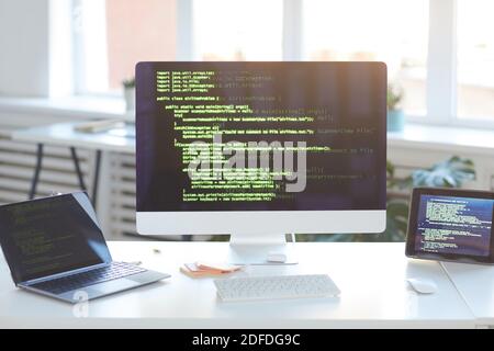 Image of computer monitor with software on the screen on the table at IT office Stock Photo