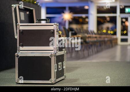 Transportation and storage of concert equipment. Containers and boxes with metal trim on wheels. Carrying crates. transportation of audio and video eq Stock Photo