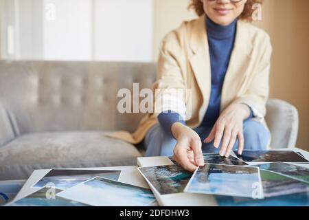 Close-up of female designer sitting in front of the table and working with professional pictures Stock Photo