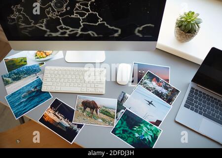 High angle view of professional photos with computer monitor on the workplace of designer at office Stock Photo