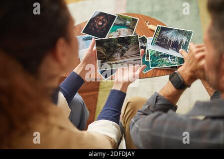 Rear view of young couple looking at their photos and remembering happy moments Stock Photo