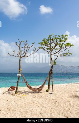 Hammock between two trees on a beach Stock Photo