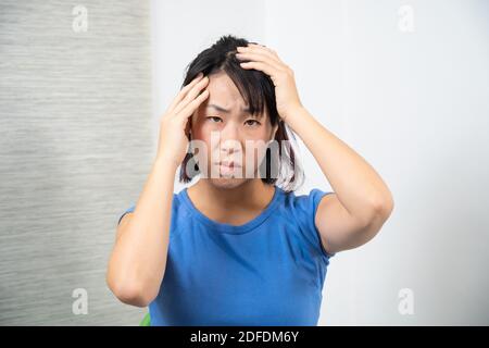 Asian woman having headache. Stock Photo