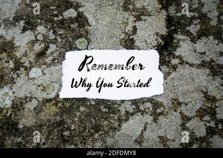 Motivational and Inspirational Quote. Remember Why You Started. Paper On Concrete. Stock Photo