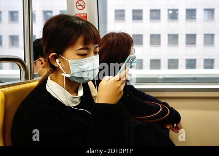 Taipei, Taipei, Taiwan. 4th Dec, 2020. A lady swiping her phone wears a mask during a ride on an autonomous train in Taipei, Taiwan. Putting on facial covers when using public transports or staying indoor remains a norm for Taiwanese people, as the island enters its 236th day without local infections nor transmissions. The island's government has ruled out stricter mask wearing measures and border control protocols to prevent the 4th wave of Covid-19 outbreak. Credit: Daniel Ceng Shou-Yi/ZUMA Wire/Alamy Live News Stock Photo