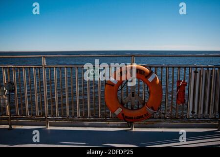 A Life Ring hangs on the edge of a ferry in North Carolina Stock Photo