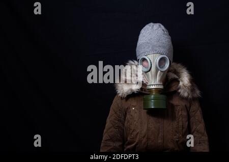 Woman in coat and mask looking sad Stock Photo