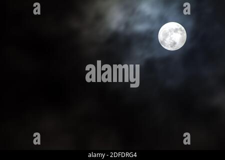 Full moon shining on dark night sky Stock Photo