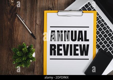 Annual Review on Clipboard over Wooden Work Desk Stock Photo