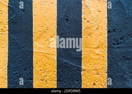 Black and yellow lines on the concrete wall texture Stock Photo