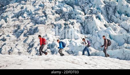 Family exploring the edges of Vatnajokull glacier in Iceland Stock Photo