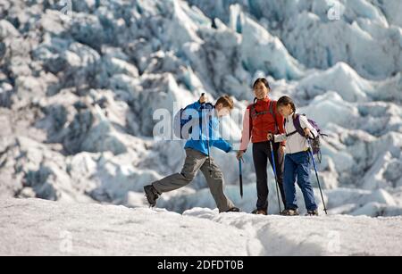 Family exploring the edges of Vatnajokull glacier in Iceland Stock Photo