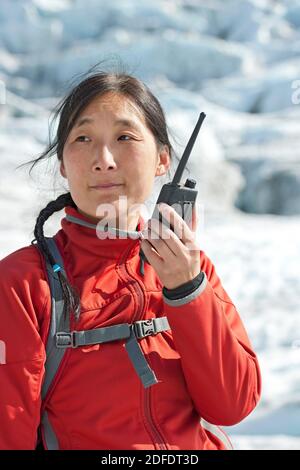 woman using radio on Vatnajokull glacier Stock Photo