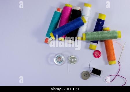 threads and buttons - tailoring materials in white background Stock Photo