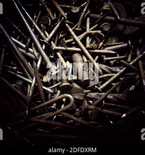 A pile of various rusty bolts, nuts, and washers for an abstract background Stock Photo